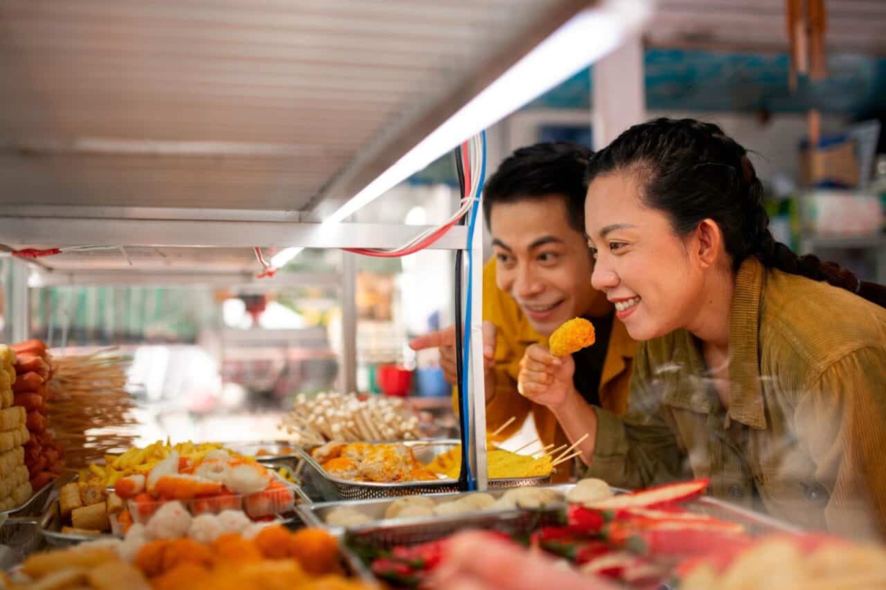 couple enjoying skewered food